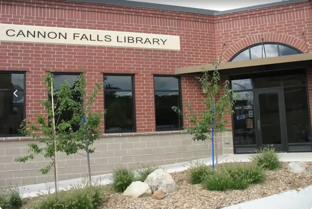 Exterior of Cannon Falls Library in Cannon Falls, Minnesota, with its brick facade, entrance and landscaping.